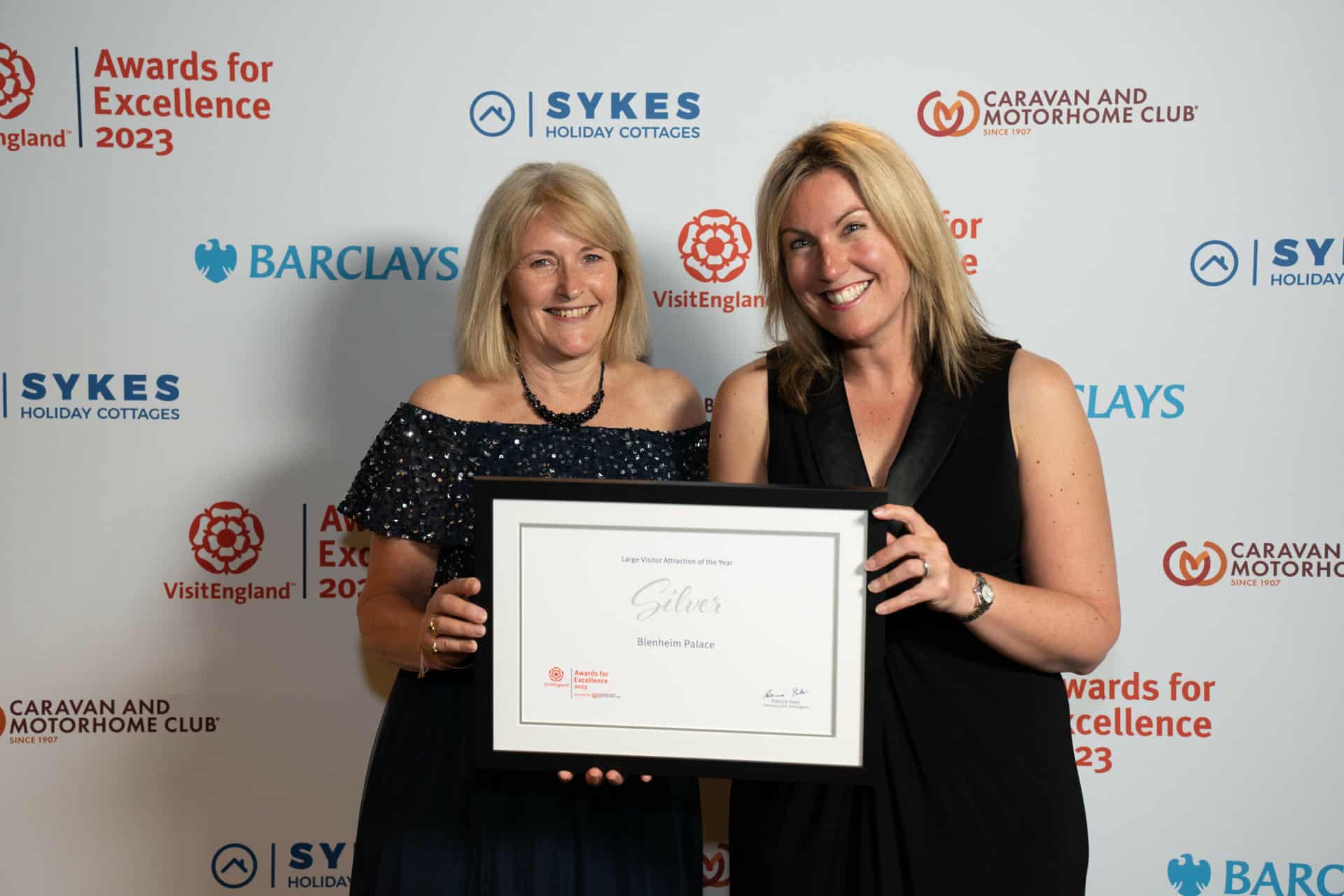 photo of the silver award winners for large visitor attraction of the year at the visitengland awards for excellence 2023 blenheim palace (representatives from blenheim palace) in front of branded photo backdrop