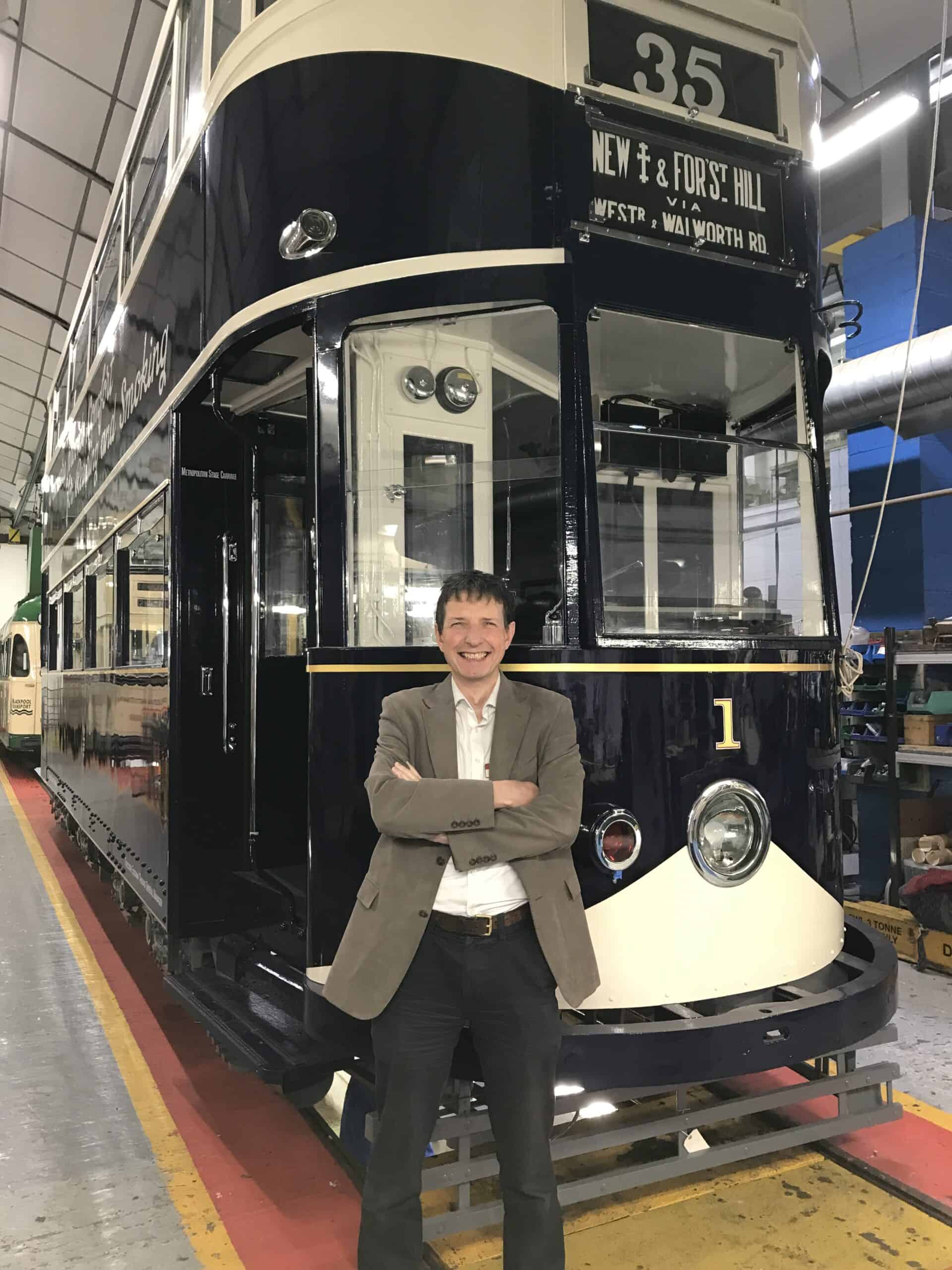 roger shelley in front of lcc1 in crich tramwy village workshop